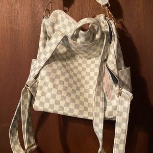 White and gray checker pattern shoulder strap or back purse.